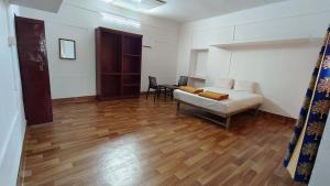 a living room with a bed and a table at Paradise Resort Vattavada, Munnar in Vattavada