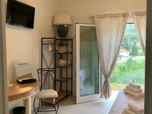 a room with a desk and a door with a window at Villa Marta bed and breakfast in Gussago