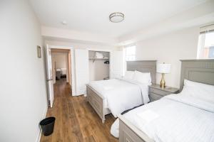 a white bedroom with two beds and a window at The Josi:Elegant space and view in Washington