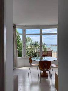 a room with a table and chairs and a large window at Sea&Harbour Arrecife in Arrecife