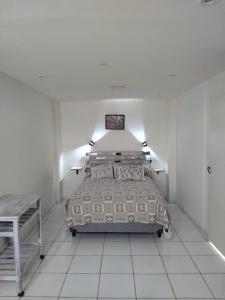 a bedroom with a bed in a white room at DAP 2 in Río Gallegos