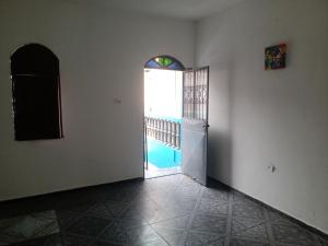 an empty room with a door and a window at Quartos Econômicos in Manaus