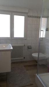 a bathroom with a tub and a toilet and a sink at FeWo Aachweg in Rielasingen-Worblingen