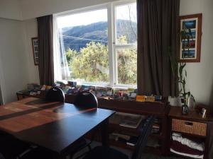 a room with two tables and a window with a view at Spa B&B in Queenstown