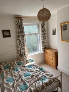 a bedroom with a bed and a window at Peaceful London Retreat in London