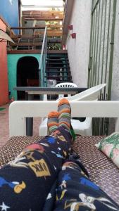 a person laying on a bench with their socks on at Patio Urbano Suites & beds in Montevideo