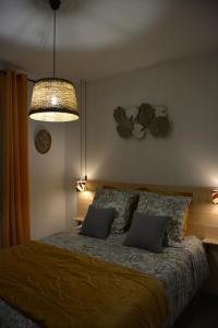 a bedroom with a bed with two pillows and a lamp at Villa ELISABETH in Aix-en-Provence