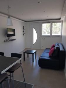 a living room with a couch and a table at Coquet et confortable Appartement T2 in Rognac