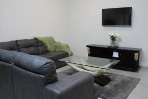 a living room with a couch and a glass table at 4499 Desert Rose in Swakopmund