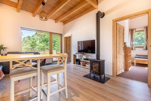 a living room with a table and a wood stove at Apartmány pod Janovským vŕškom in Plavecký Svätý Mikuláš