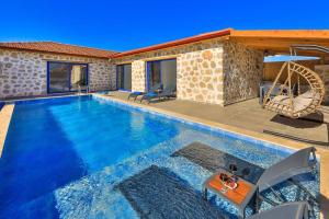 a swimming pool with a playground in a house at Villa Flower Blue Patara in Gelemiş