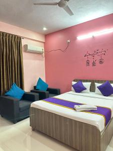 una camera con un grande letto e una parete rosa di Hotel Golden Stays a Bangalore