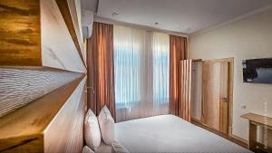 a bedroom with two bunk beds and a window at Hotel Bankir Khiva in Khiva