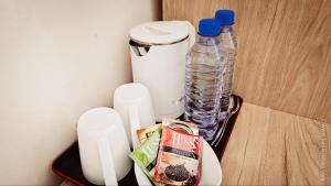 a drawer with two bottles of water and a box of food at Hotel Bankir Khiva in Khiva