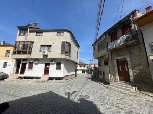 un callejón con un viejo edificio en una calle en At Pikotiko's - Korca City Rooms for Rent en Korçë