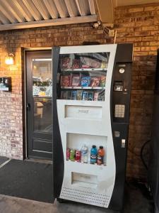 a vending machine with food and drinks in it at Marco Polo Motel in Seattle