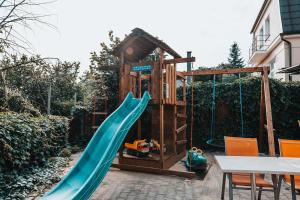 a playground with a slide and a play house at Penzion Hurikán 63 in Havlickuv Brod