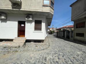 um edifício com uma porta ao lado de uma rua em At Pikotiko's - Korca City Rooms for Rent em Korçë