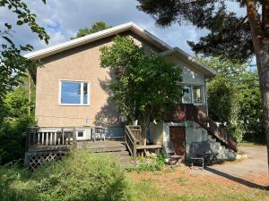 a house with a porch and a tree at Tonnila, big villa for 10-Person at Turku near Meyer gate in Turku