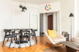 a living room with a dining room table and chairs at Cosy apart Antwerp city center1 in Antwerp