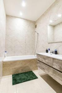 a white bathroom with a tub and a sink at Cosy apart Antwerp city center1 in Antwerp