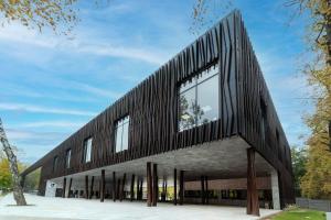 a black and white building with windows at Baron Apartments Orientarium,Aquapark Fala & Park in Łódź