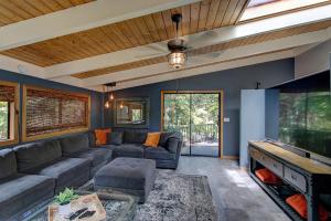 a living room with a couch and a large aquarium at Halehikiola home in Volcano