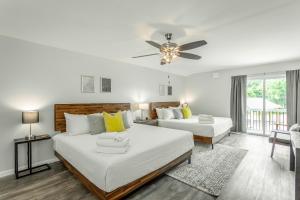 a bedroom with two beds and a ceiling fan at 01 The Eames Suite - A PMI Scenic City Vacation Rental in Chattanooga
