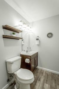 a white bathroom with a toilet and a sink at 01 The Eames Suite - A PMI Scenic City Vacation Rental in Chattanooga