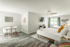 a white bedroom with a bed and a table at 02 The Wright Suite - A PMI Scenic City Vacation Rental in Chattanooga