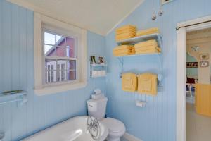 a blue bathroom with a tub and a toilet and towels at Cozy Fiddlers Rest Cabin 11 Miles to Skiing! in Bernardston +22 photos