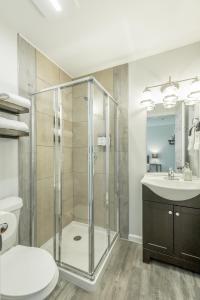 a bathroom with a shower and a toilet and a sink at 08 The Evans Room - A PMI Scenic City Vacation Rental in Chattanooga +22 photos