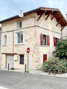 a brick building with a stop sign in front of it at Le St Apollinaire n°2-Ma Cabotte in Meximieux