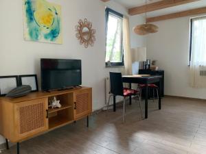 a living room with a tv and a table at La Bohème in Groß Köris