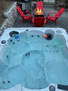 a jacuzzi tub with a table and chairs in a backyard at Eagle's View Penthouse in Victoria
