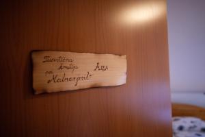 un trozo de papel en una puerta con letra. en Domačija Malnarjevi, en Villa Slavina