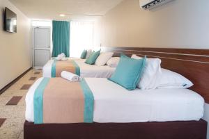 Postel nebo postele na pokoji v ubytování Hotel Portobelo Convention Center
