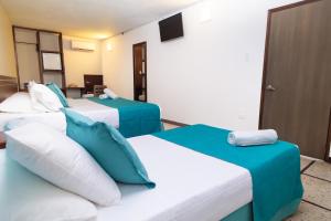 Postel nebo postele na pokoji v ubytování Hotel Portobelo Convention Center
