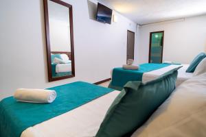 Postel nebo postele na pokoji v ubytování Hotel Portobelo Convention Center