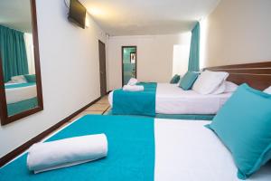 Postel nebo postele na pokoji v ubytování Hotel Portobelo Convention Center