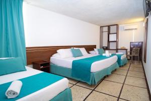 Postel nebo postele na pokoji v ubytování Hotel Portobelo Convention Center