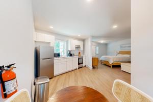 a kitchen and living room with a bed in a room at Town of Rehoboth Beach - 99 Sussex St Unit #6 in Rehoboth Beach