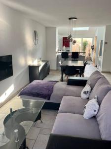 a living room with a couch and a table at Maison proche CNPE in Saint-Folquin