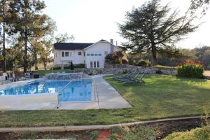 a house with a swimming pool in the yard at 1940 Farmhouse with Pool in Newcastle