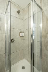 a shower with a glass door in a bathroom at 14 The Nelson Room - A PMI Scenic City Vacation Rental in Chattanooga