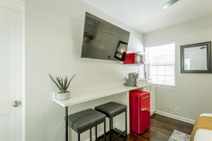 a small kitchen with a white counter and stools at 14 The Nelson Room - A PMI Scenic City Vacation Rental in Chattanooga