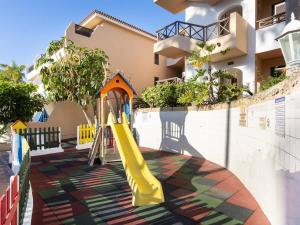 a playground with a slide in front of a building at Apartamentos Golf del Sur Tenerife in San Miguel de Abona
