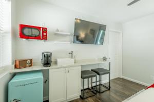 a kitchen with a sink and a red tv on the wall at 11 The Charlotte Room - A PMI Scenic City Vacation Rental in Chattanooga +19 photos