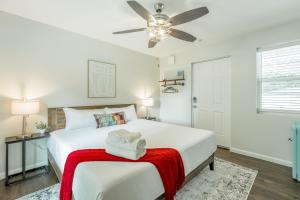 a white bedroom with a bed with two towels on it at 11 The Charlotte Room - A PMI Scenic City Vacation Rental in Chattanooga