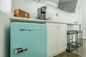 a kitchen with a refrigerator and a sink at 11 The Charlotte Room - A PMI Scenic City Vacation Rental in Chattanooga